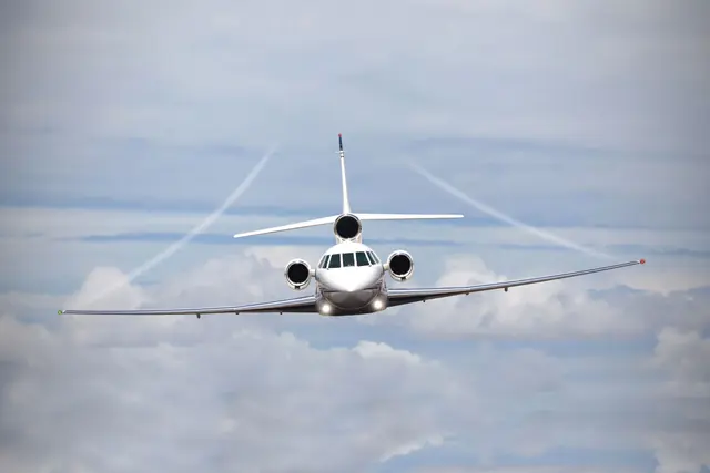 Private jet flying above the clouds